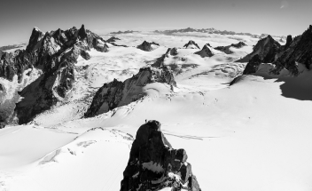 Black and white shot of mountain top snow